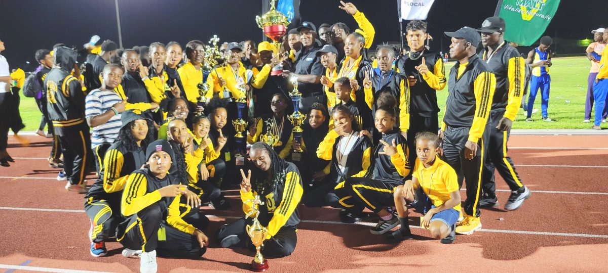 Champs Again! Athletes, Teachers and officials of District 10 pose with the coveted Champion of Champions trophy during the closing ceremony of the 61st edition of the National Schools Swimming, Cycling and Track and Field Championships 
