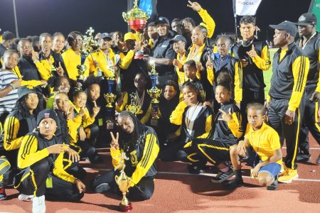 Champs Again! Athletes, Teachers and officials of District 10 pose with the coveted Champion of Champions trophy during the closing ceremony of the 61st edition of the National Schools Swimming, Cycling and Track and Field Championships 
