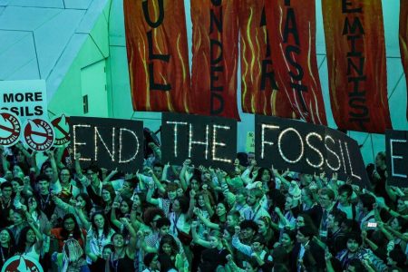 Climate activists attend a protest against fossil fuels during the United Nations Climate Change Conference COP28 in Dubai on December 12, 2023. (Photo by Giuseppe CACACE / AFP) (Photo by GIUSEPPE CACACE/AFP via Getty Images)
