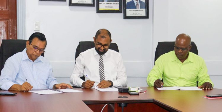 Chief Labour Officer, Dhaneshwar Deonarine (centre) and the executives from  GPL and the union affixing their signatures to the MOU.  (Ministry of Labour photo)