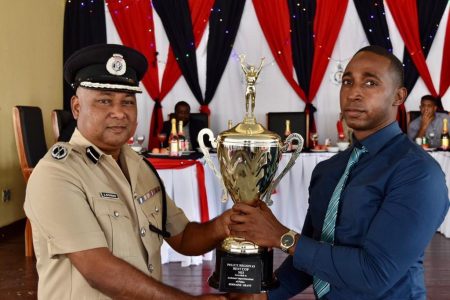 Deputy Commissioner Ravindradat Budhram (left) presenting the Best Cop
trophy to Assistant Superintendent Jermaine Grant (Police photo)