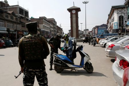 Indian Central Reserve Police Force (CRPF) personnel check the bags of a scooterist as part of security checking in Srinagar, October 12, 2021. REUTERS/Danish Ismail