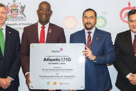 Prime Minister Dr Keith Rowley (second from left) and Minister of Energy and Energy Industries Stuart Young (third from left) hold a commemorative plaque after the signing of the commemorative document in London on Tuesday. Also in picture, at left, are bpTT president David Campbell and NGC president Mark Loquan.