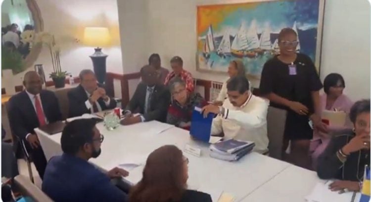 President Nicolas Maduro on Thursday in St Vincent with a stack of documents in from of him.