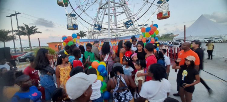 Excited patrons waiting to ride the Ferris wheel 