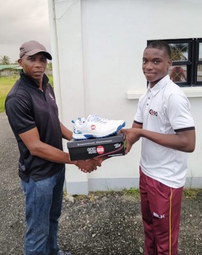 Shamar Apple (right) receiving the donation from Shawn Massiah, which was facilitated by the ‘Cricket Gear for Young and Promising Cricketers in Guyana’ project.