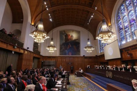 People sit inside the International Court of Justice (ICJ) on the day of the trial to hear a request for emergency measures by South Africa, who asked the court to order Israel to stop its military actions in Gaza and to desist from what South Africa says are genocidal acts committed against Palestinians during the war with Hamas in Gaza, in The Hague, Netherlands, January 11, 2024. (Reuters photo) 