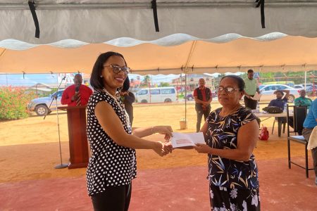 Minister of Tourism Industry and Commerce Oneige Walrond (left) handing over a cheque to a recipient