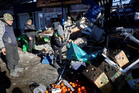 People remove debris at a food market following, what local Russian-installed authorities say, was a Ukrainian military strike in the course of Russia-Ukraine conflict in Donetsk, Russian-controlled Ukraine, January 21, 2024. (Reuters photo)