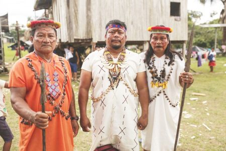 Siekopai leader Justino Piaguaje [middle] stands alongside two community members in their ancestral homeland on the Ecuador-Peru border, Pëkëya. Credit: Jerónimo Zúñiga / Amazon Frontlines