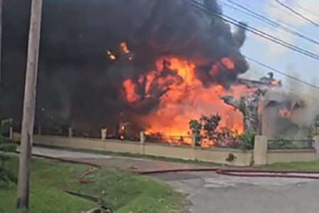 The house at New Providence engulfed in flames
