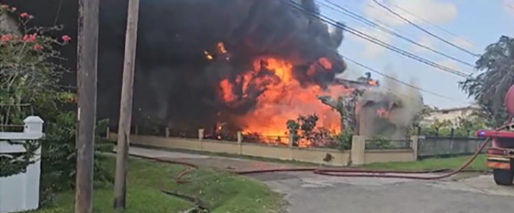 The house at New Providence engulfed in flames
