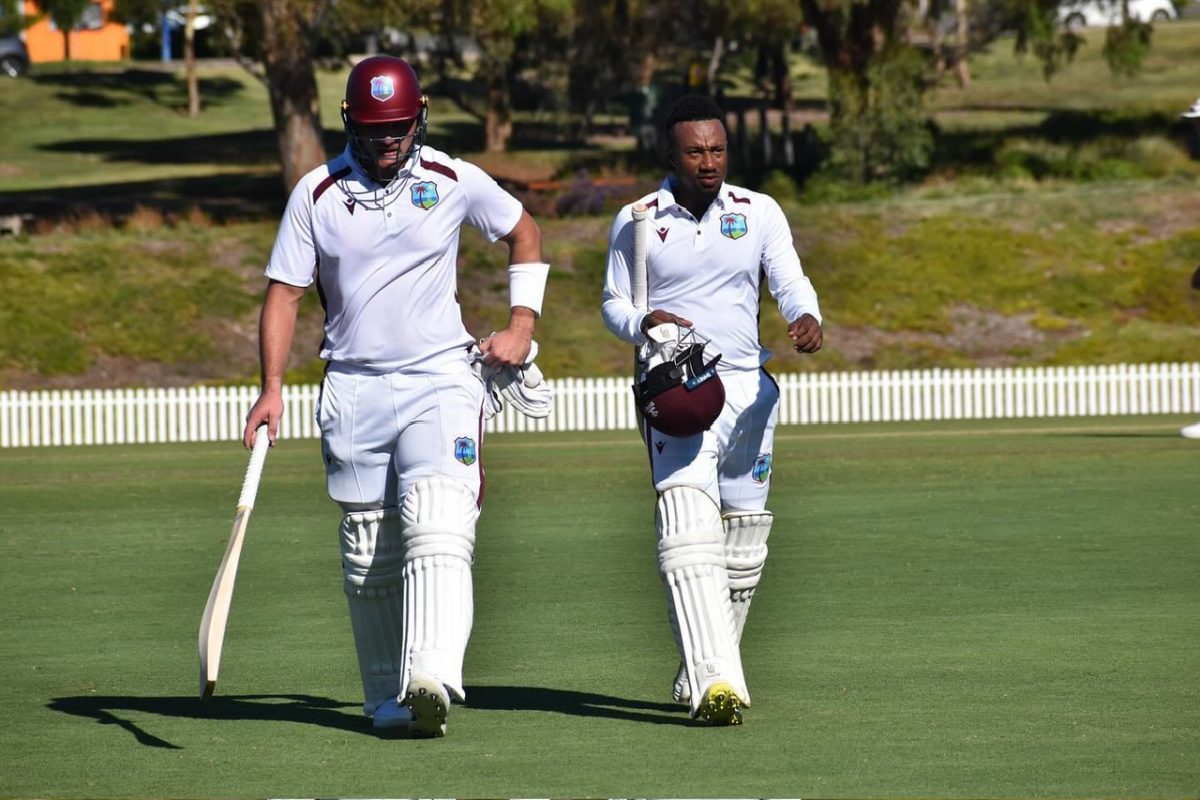 Joshua Da Silva (left) and Kavem Hodge depart the playing area at the end of day two after recording an unbeaten half-century stand