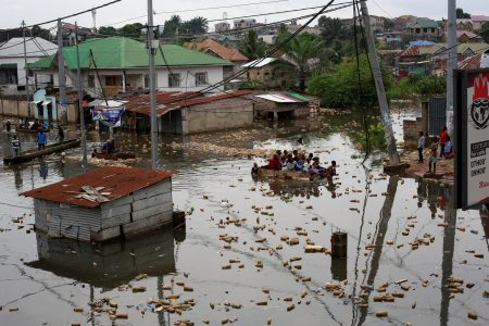 People use a makeshift boat to move after the Congo River rises to its highest level, causing flooding. Kinshasa, Democratic Republic of Congo January 10, 2024.REUTERS/Justin Makangara