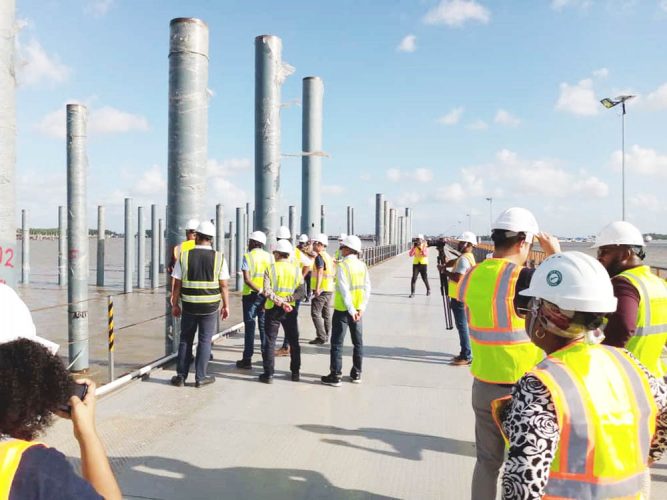 Members of the media and representatives from Polytechnica inspecting work on the 100 percent completed temporary structure of the Demerara Harbour Bridge