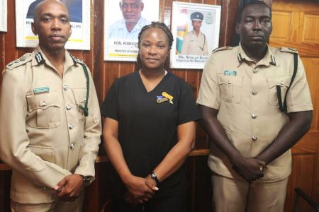 Falane Grant (centre) with Director of Prisons, Nicklon Elliot (left) (GPS photo)