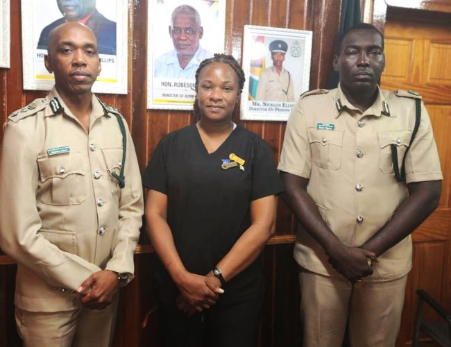 Falane Grant (centre) with Director of Prisons, Nicklon Elliot (left) (GPS photo)