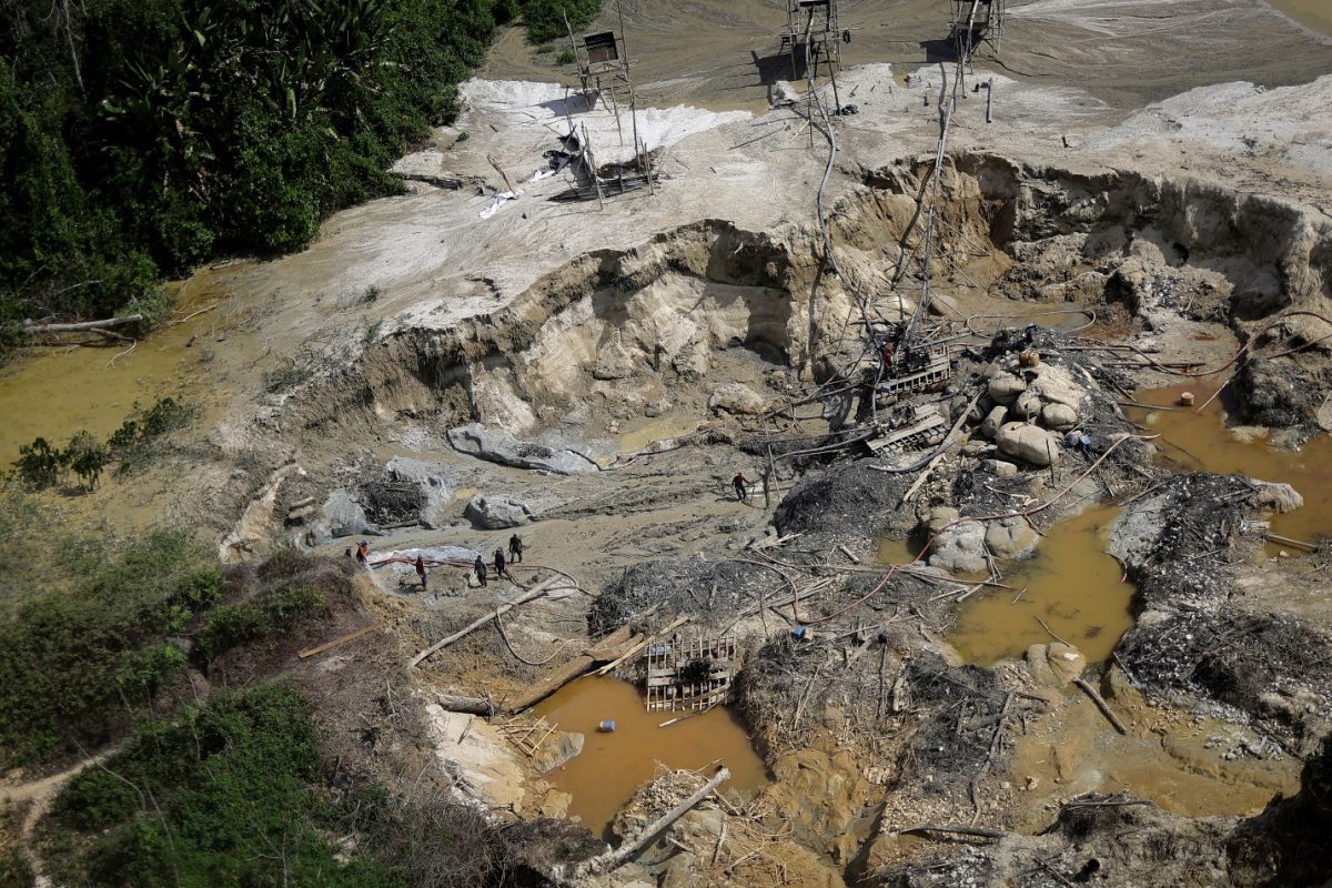 Illegal miners are caught using jets of water to dig for gold, damaging the soil by the edge of the Couto de Magalhaes river, during an operation by members of the Special Inspection Group from the Brazilian Institute of Environment and Renewable Natural Resources (IBAMA) against illegal mining in Yanomami Indigenous land, Roraima state, Brazil, December 3, 2023. The destruction of the rainforest was evident from gaping pits some five meters (16 ft) deep in mining sites cleared of trees, along with dozens of ponds where dredged sludge was pumped into rivers, turning pristine waters a bright orange from the mud. REUTERS/Ueslei Marcelino
