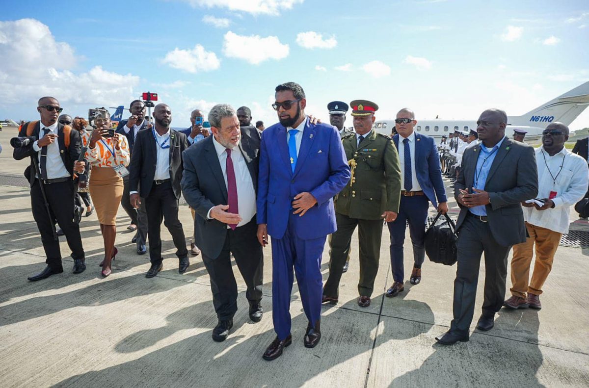 Prime Minister of St Vincent and the Grenadines, Ralph Gonsalves (left in foreground) greeting President Irfaan Ali after his arrival at Argyle on December 14. (Office of the President photo)

