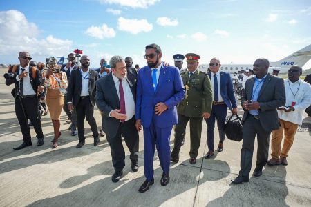 Prime Minister of St Vincent and the Grenadines, Ralph Gonsalves (left in foreground) greeting President Irfaan Ali after his arrival at Argyle on December 14. (Office of the President photo)