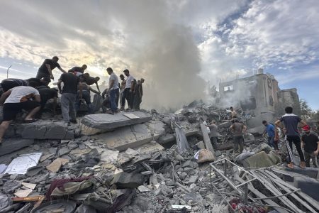 Palestinians look for survivors following Israeli airstrike in Nusseirat refugee camp, Gaza Strip, Tuesday, Oct. 31, 2023. (AP Photo/Doaa AlBaz)