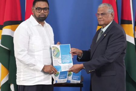 Major General (Rtd) Joe Singh (right) handing over the report to President Irfaan Ali (Department of Public Information photo)