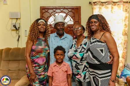 Lorip Mc Donald with his family on Friday (Ministry of Human Services photo)