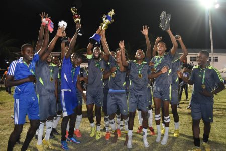 A jubilant Monedderlust FC celebrates with their trophy after defeating Slingerz FC 1-0 to secure promotion to the upcoming GFF Elite League season