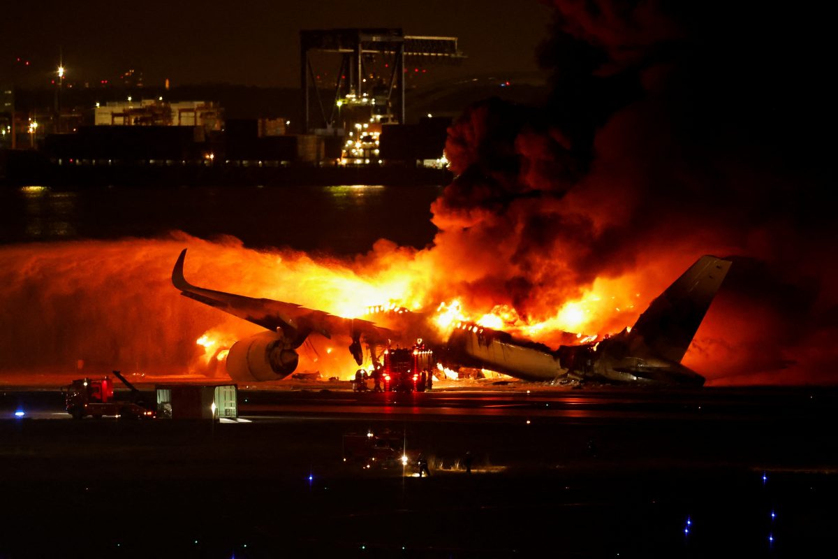 Firefighters work at Haneda International Airport after Japan Airlines’ A350 airplane caught on fire,  in Tokyo, Japan January 2, 2024. REUTERS/Issei Kato