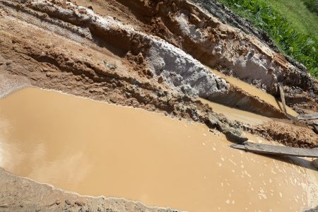A sunken part of the roadway
