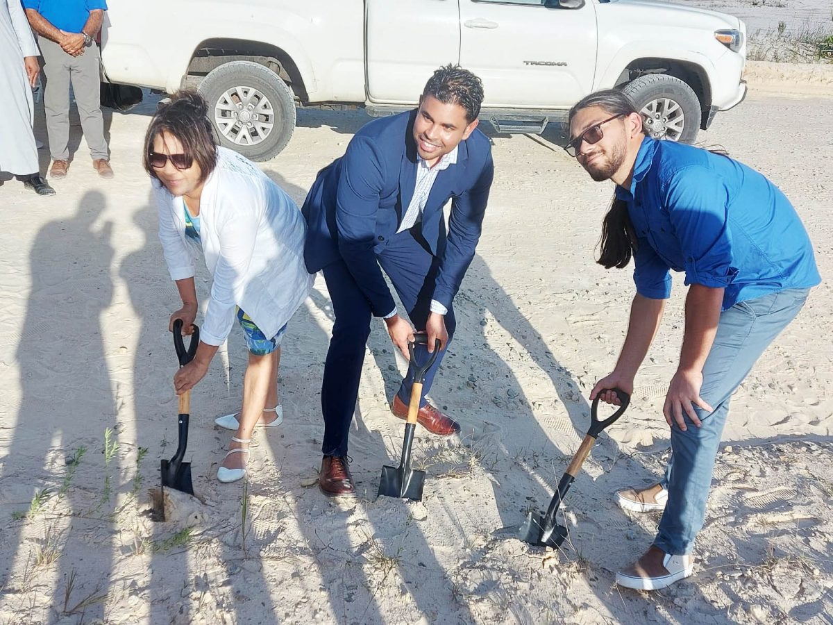 Minister of Culture, Youth and Sports Charles S Ramson Jnr (centre) flanked by investor Hesaan DaSilva (left) and son Aaron DaSilva (right) as they turned the sod