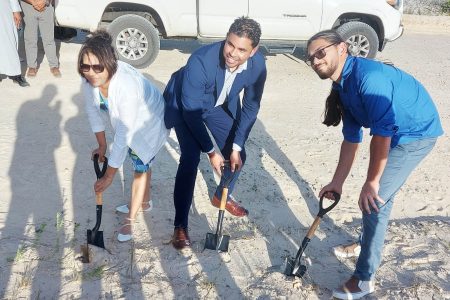 Minister of Culture, Youth and Sports Charles S Ramson Jnr (centre) flanked by investor Hesaan DaSilva (left) and son Aaron DaSilva (right) as they turned the sod