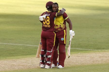 Andre Russell (right) and Sherfane Rutherford shared a record T20I sixth wicket partnership of 139, which rescued the West Indies from 79-5.