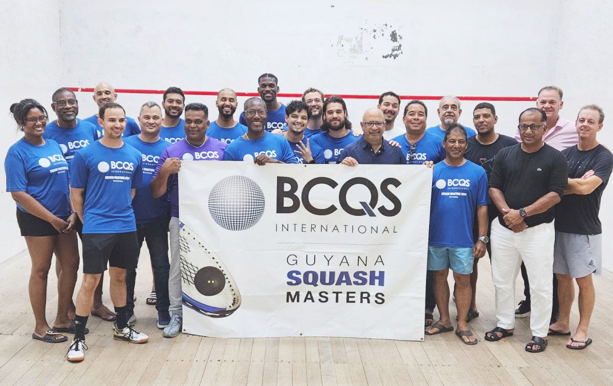 The participants, including the divisional winners and third-place finishers in the BCQS Masters Squash Championship, pose with their spoils following the conclusion of the event at the Georgetown Club, Camp Street.