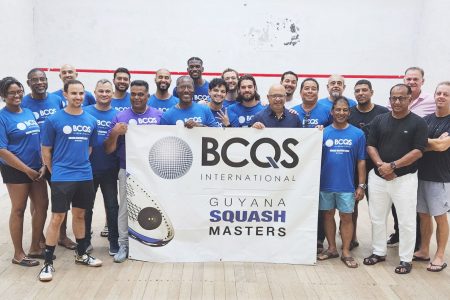 The participants, including the divisional winners and third-place finishers in the BCQS Masters Squash Championship, pose with their spoils following the conclusion of the event at the Georgetown Club, Camp Street.