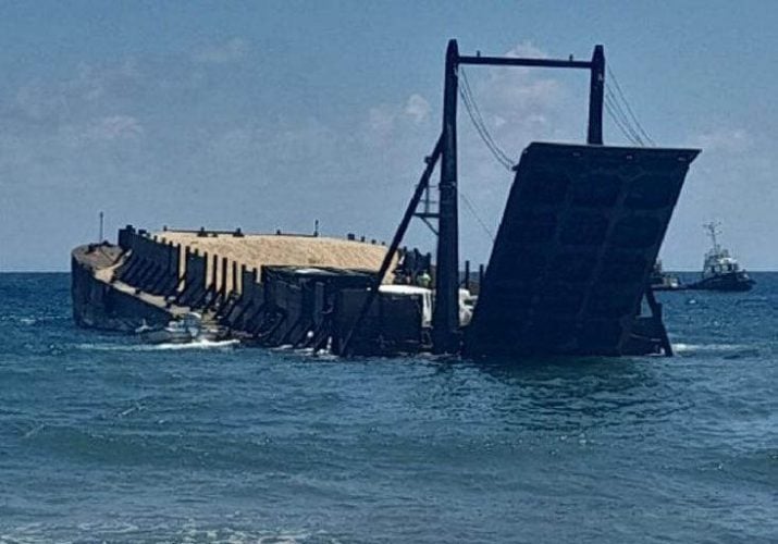 The barge carrying aggregate that residents of Hope Beach and environs say is listing badly and is now in danger of sinking.