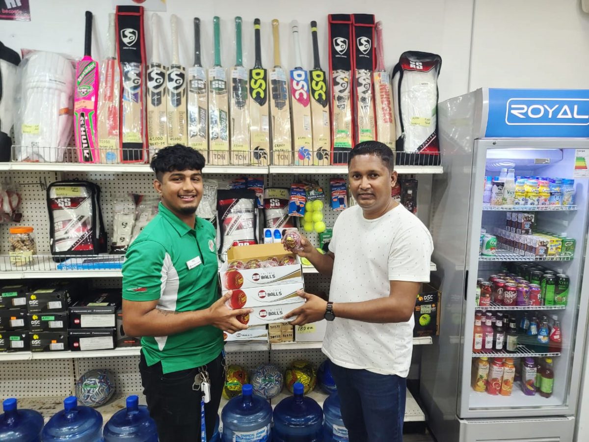 Cricket Equipment Guyana’s Manager Chanderpaul Mohamed (left) hands over the balls to DCB’s Treasurer Vicky Bharosay.
