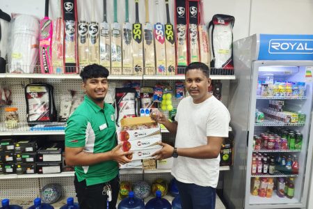 Cricket Equipment Guyana’s Manager Chanderpaul Mohamed (left) hands over the balls to DCB’s Treasurer Vicky Bharosay.