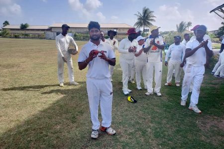 Totaram Bishun is applauded by his teammates after his 6/22 bundled out Transport for just 80 in their second inning