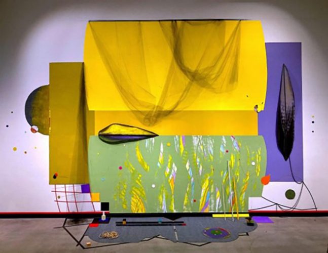 Carl E Hazlewood, Blackhead Anansi Sails Across the Savannah, acrylic and latex paint, tape, plastic netting, polyester material, cut paper, map pins, push pins, wood, rope, oil pastels, roofing velvet, faux diamonds, metallic string, polyester rope. 30’ x 40’ x 8.’ 2023. (Photo: Courtesy of the artist.)