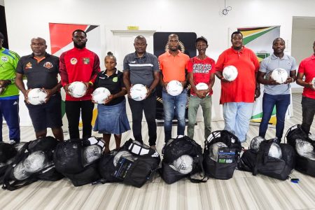 Representatives from the competing teams are displaying the donated equipment that will be utilised during the Elite League
