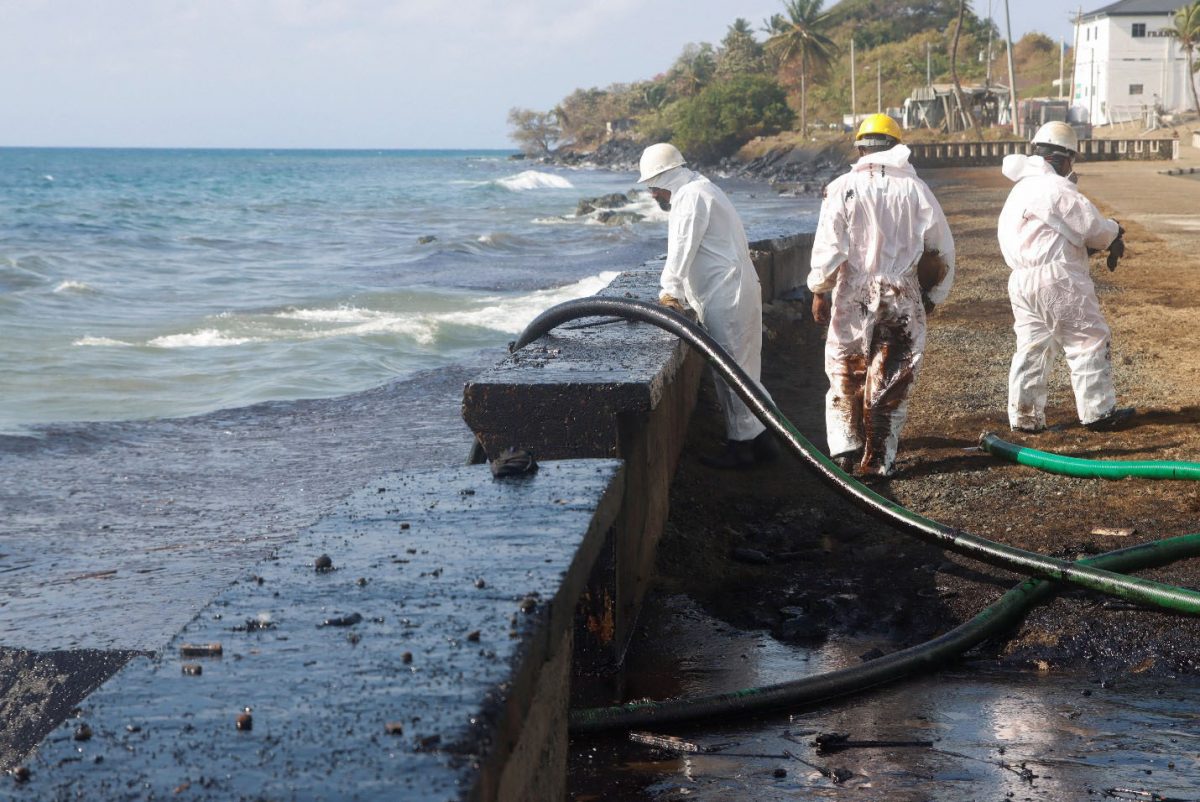 Workers of Oil Mop Environmental Services (OMES) suction oil from a spill at Magdalena Grand Resort, in Tobago Island, Trinidad and Tobago, February 16, 2024. REUTERS/Clement George Williams