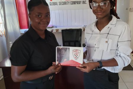 Administrative Assistant at Nel Global Security Inc., Sharay Johnson (right), made the presentation to tournament representative Samarca Evelyn yesterday