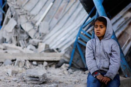 Palestinian child sits at the site of an Israeli strike on a house, amid the ongoing conflict between Israel and the Palestinian Islamist group Hamas, in Rafah in the southern Gaza Strip, February 7, 2024. (Reuters photo)