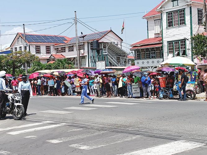 Protesters outside the MoE Brickdam office. 