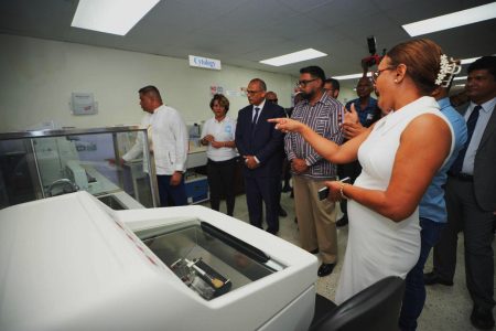 This is how it works: This hospital official is seen explaining to President Irfan Ali, Minister of Health Dr Frank Anthony and others how the telepathology lab at the Georgetown Public Hospital works. The Ministry of Health in collaboration with the Mount Sinai Health System of New York, USA yesterday unveiled the state-of-the-art Telepathology Laboratory at the hospital. (Office of the President photo)