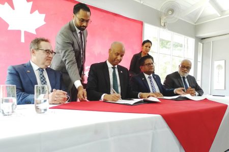 Seated from left: Canadian High Commissioner to Guyana Mark Berman, Canadian Minister of International Development Ahmed Hussen, and Minister of Finance Dr Ashni Singh and Anton Edwards General Manager at the IDB’s Caribbean Country Department at the signing of the sovereign loan agreement (Antonio Dey)