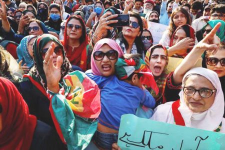 A supporter of former Prime Minister Imran Khan’s party, the Pakistan Tehreek-e-Insaf (PTI), carries her son while chanting slogans along with others during a protest demanding free and fair results of the elections, outside the provincial election commission office in Karachi, Pakistan February 11, 2024. (Reuters photo)