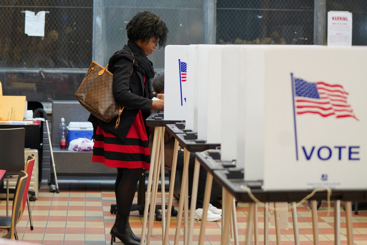 A woman votes at a voting site as Democrats and Republicans hold their Michigan primary presidential election, in Detroit, Michigan, U.S. February 27, 2024. REUTERS/Dieu-Nalio Chery