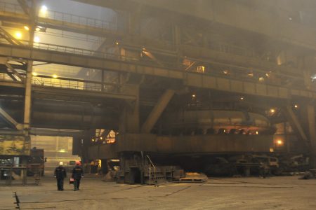 Employees walk past the blast furnace "Rossiyanka" at the Novolipetsk (NLMK) steel mill in Lipetsk, about 500 km (311 miles) southeast of the capital Moscow, January 30, 2014. REUTERS/Andrey Kuzmin/File photo